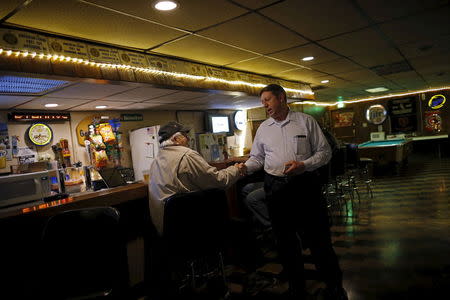 U.S. Republican presidential candidate Michael Petyo speaks to a patron while campaigning at the American Legion in Highland, Indiana, United States, December 15, 2015. REUTERS/Jim Young