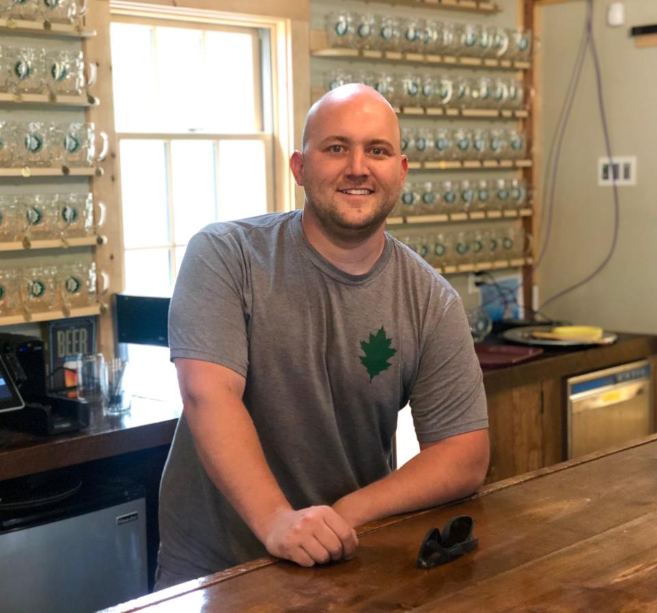 Andrew Woodward, head brewer and co-founder of Oakholm Brewing Co. in Brookfield, stands in his taproom, transformed from a dusty 90-year-old barn.