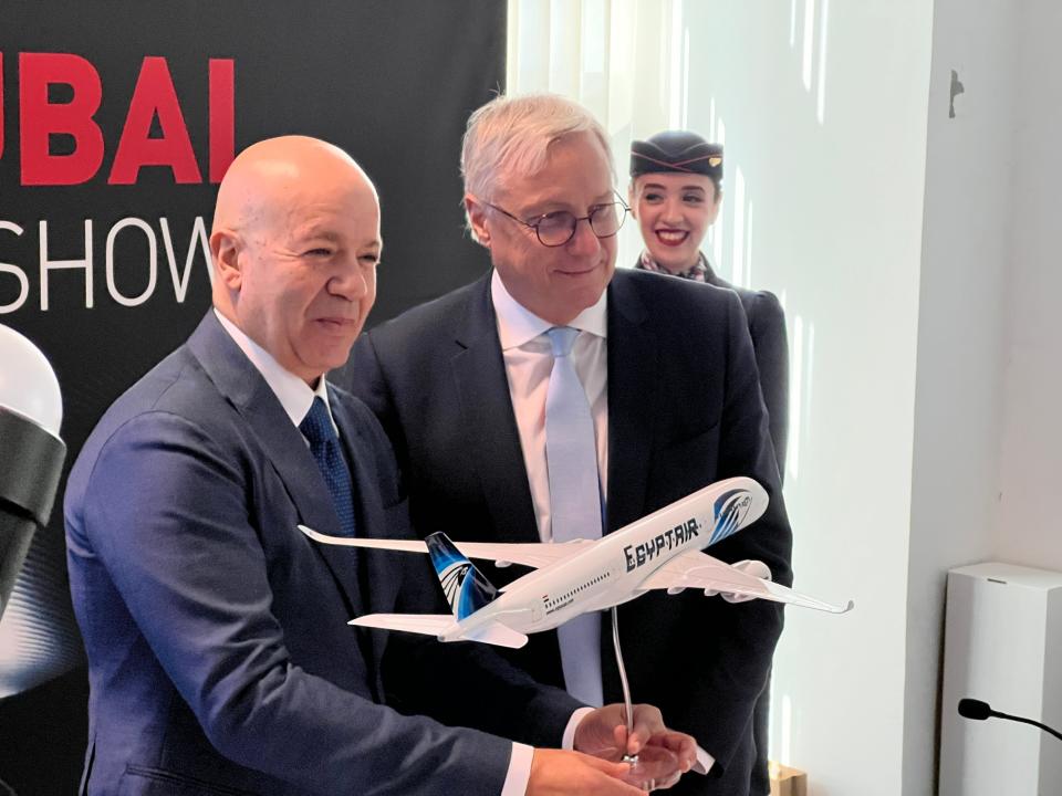 EgyptAir CEO Yehia Zakaria and Airbus Chief Commercial Officer Christian Scherer hold an EgyptAir model and smile at the Dubai Airshow.