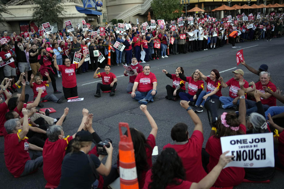 Members of the Culinary Workers Union block traffic along the Strip, Wednesday, Oct. 25, 2023, in Las Vegas. Thousands of hotel workers fighting for new union contracts rallied Wednesday night on the Las Vegas Strip, where rush-hour traffic was disrupted when some members blocked the road before being detained by police. (AP Photo/John Locher)