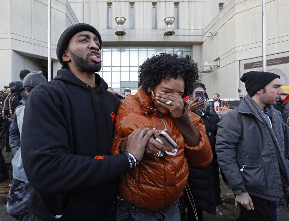 A man helps Yandy Smith after she received pepper spray when she and others stormed the main entrance to the Metropolitan Detention Center, a federal facility where protesters say prisoners have gone without heat, hot water and flushing toilets due to an electrical outage, Sunday, Feb. 3, 2019, in New York. (AP Photo/Kathy Willens)