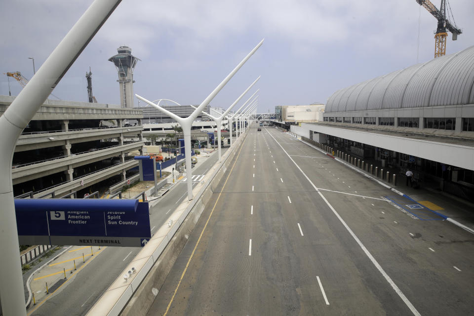 A empty street is seen at the Los Angeles International Airport Thursday, May 28, 2020, in Los Angeles. From Britain's EasyJet to American and Delta in the U.S., airlines are cutting even more jobs to cope with a crushing drop in air travel caused by the coronavirus. (AP Photo/Marcio Jose Sanchez)