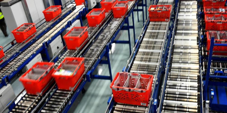 FILE PHOTO: A general view shows conveyer belts transporting crates filled with packed bags inside the Ocado Customer Fulfilment Centre in Hatfield on the outskirts of London, Britain, April 6, 2016 .  REUTERS/Dylan Martinez/File Photo