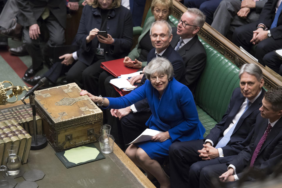 Britain's Prime Minister Theresa May reacts after she won a no-confidence vote against her government, in the House of Commons, London, Wednesday Jan. 16, 2019. Prime Minister Theresa May won the no confidence vote called for by opposition Labour Party leader Jeremy Corbyn, following the dramatic failure of the government Brexit vote. (Jessica Taylor, UK Parliament via AP)