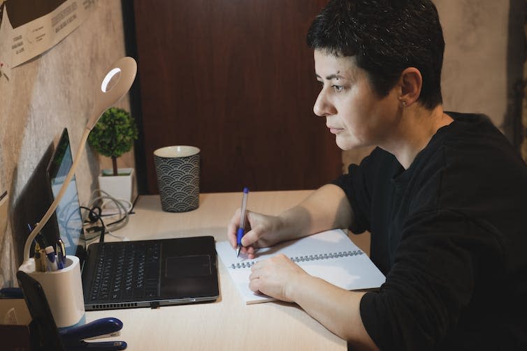 Woman looking at laptop