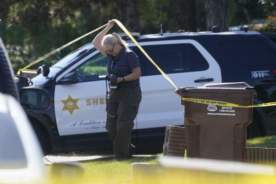 A forensic investigator leaves the home of Bishop David O'Connell in Hacienda Heights, Calif., Sunday, Feb. 19, 2023. O'Connell was shot and killed Saturday just blocks from a church, a slaying of a longtime priest hailed as a “peacemaker” that's stunned the Los Angeles religious community, authorities said. Detectives are investigating the death as a homicide, according to the Los Angeles County Sheriff's Department. (AP Photo/Damian Dovarganes)