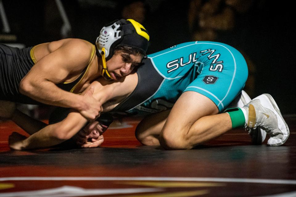 Hesperia’s Emiliano Hernandez, left, battles against Sultana’s Aaron Mesa on Wednesday, Jan. 18, 2023. Hesperia won the match 54-24.