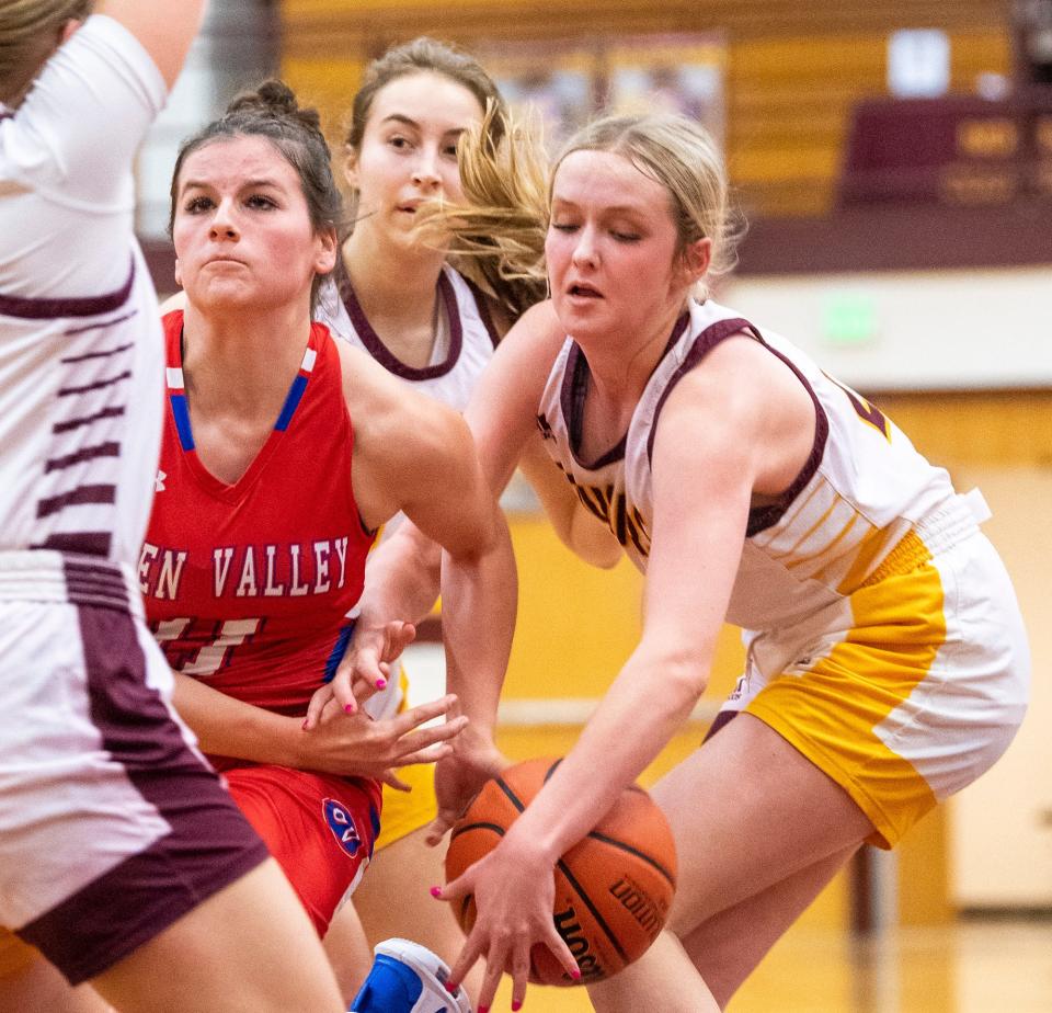 Bloomington North's Ava Reitmeyer (21) steals the ball from Owen Valley's Taylor York (11) during the Bloomington North versus Owen Valley girls basketball game at Bloomington North High School on Tuesday, Dec. 6, 2022.