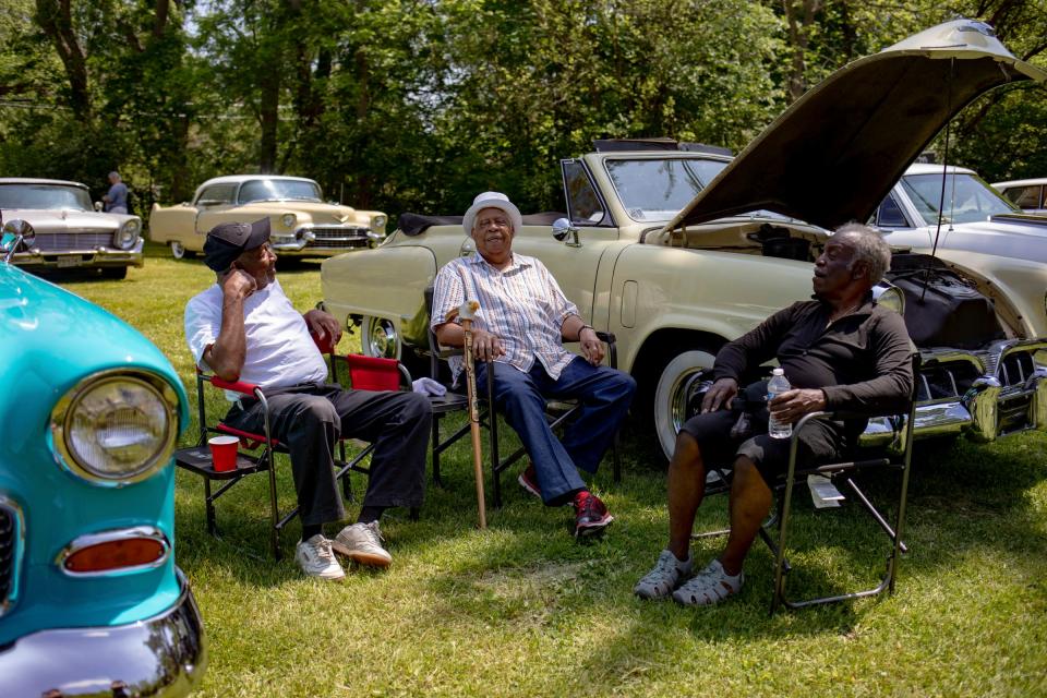 Left to right, Leon Callaway, Horace Rogers, and Norris Goudy converse during a Friends with Classic Cars event on May 18, 2024, at Etheldra Mae Williams Park in the Brightmoor neighborhood in Detroit.