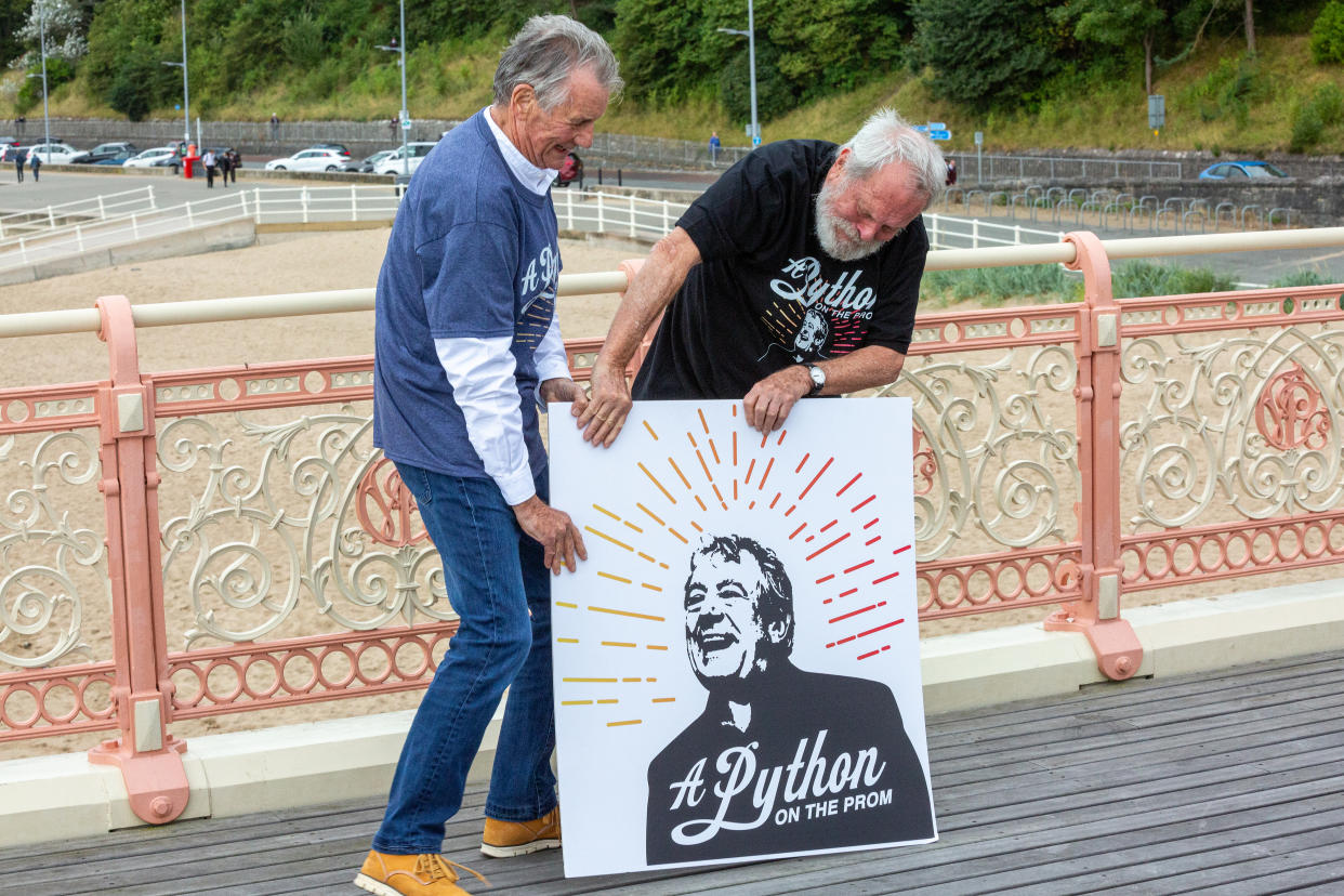 Sir Michael Palin and Terry Gilliam with a picture of Terry Jones