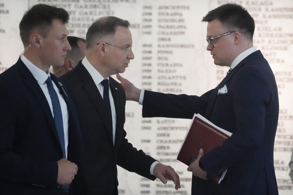 Poland's President Andrzej Duda, second left, tals to Parliament Speaker Szymon Holownia, right, after a speech by Foreign Minister Radek Sikorski, in the Polish parliament in Warsaw, Poland, Thursday, April 25, 2024. (AP Photo/Czarek Sokolowski)