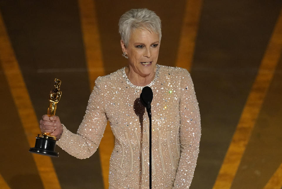 Jamie Lee Curtis accepts the award for best performance by an actress in a supporting role for "Everything Everywhere All at Once" at the Oscars on Sunday, March 12, 2023, at the Dolby Theatre in Los Angeles. (AP Photo/Chris Pizzello)