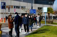 People queue to get tested for the coronavirus disease (COVID-19) after the Christmas holiday break, amid the COVID-19 pandemic, at Doce de Octubre Hospital in Madrid