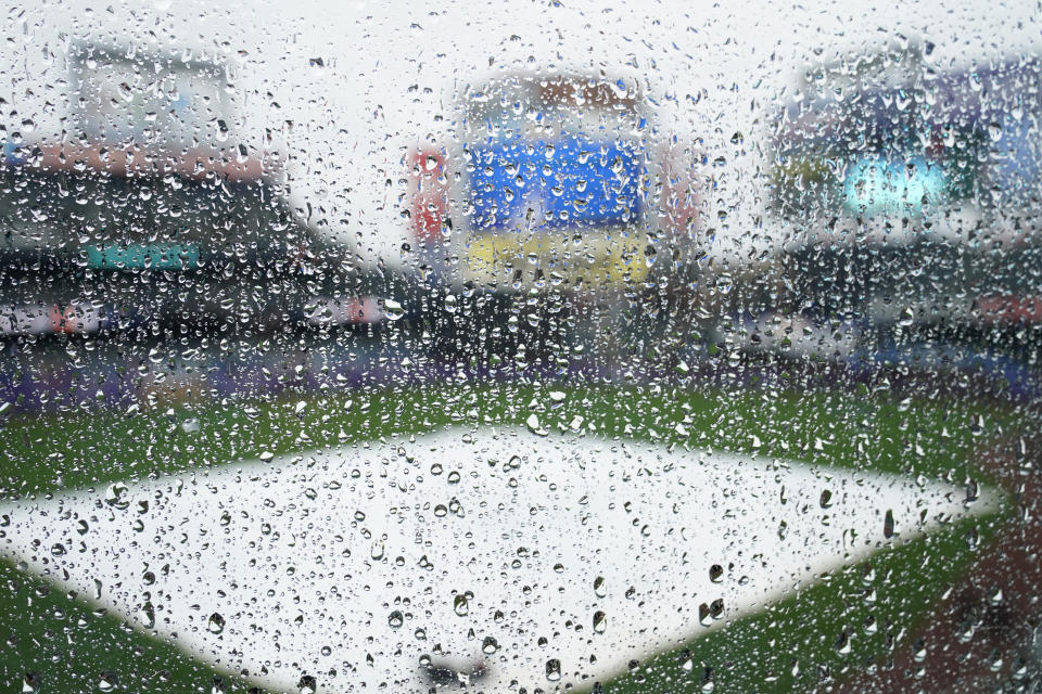 Raindrops cover a plastic barrier on the upper deck at Citi Field as a baseball game between the New York Mets and the Atlanta Braves is postponed due to rain, Sunday, May 30, 2021, in New York. (AP Photo/Kathy Willens)