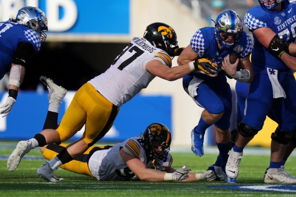 Jan 1, 2022; Orlando, FL, USA; Iowa Hawkeyes defensive lineman Zach VanValkenburg (97) reaches for Kentucky Wildcats quarterback Will Levis (7) during second half in the 2022 Citrus Bowl at Camping World Stadium. Mandatory Credit: Jasen Vinlove-USA TODAY Sports