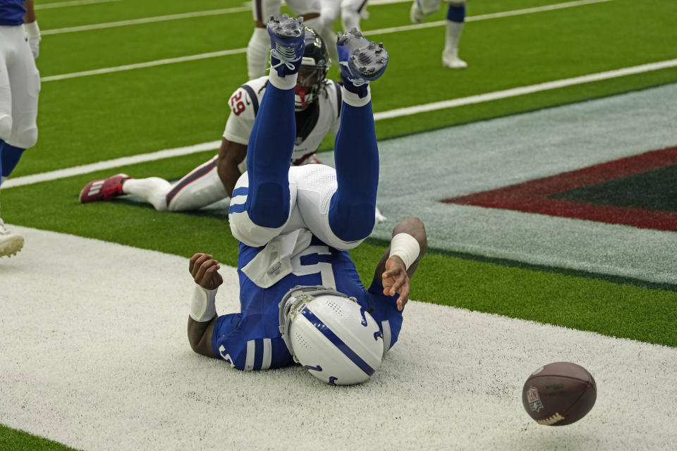 Indianapolis Colts quarterback Anthony Richardson (5) rolls backwards after rushing for a touchdown against the Houston Texans during an NFL football game Sunday, Sept. 17, 2023, in Houston. (AP Photo/David J. Phillip)