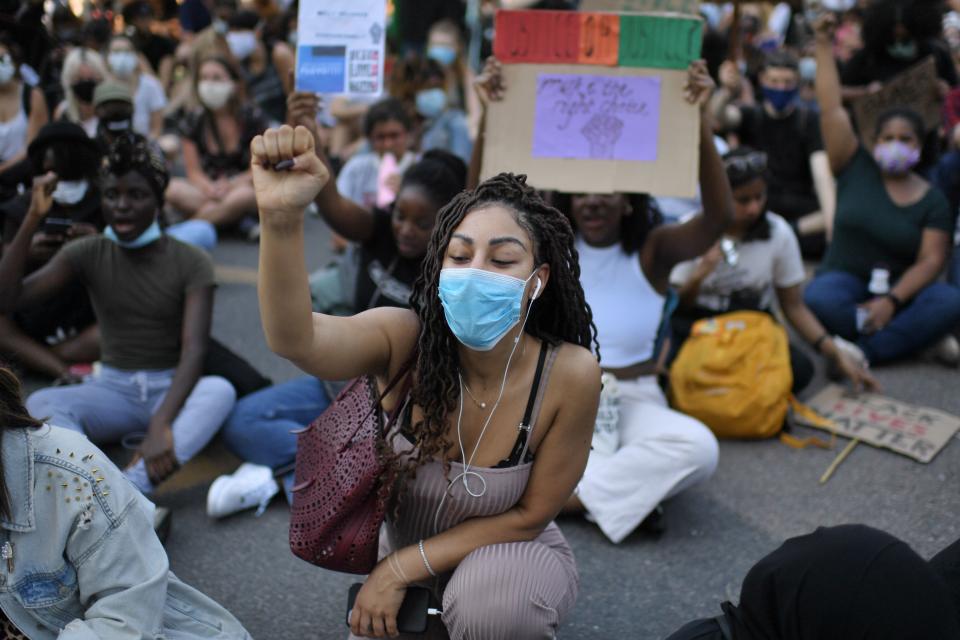 Demonstrators sit down in the road outside the US Embassy in London on May 31, 2020 to protest the death of George Floyd, an unarmed black man who died after a police officer knelt on his neck for nearly nine minutes during an arrest in Minneapolis, USA. - Hundreds gathered in central London and marched to teh US Embassy to protest the death of an unarmed black man in Minneapolis while in police custody that has sparked days of unrest in the US city and beyond. (Photo by DANIEL LEAL-OLIVAS / AFP) / The erroneous mention[s] appearing in the metadata of this photo by DANIEL LEAL-OLIVAS has been modified in AFP systems in the following manner: [London] instead of [Brighton]. Please immediately remove the erroneous mention[s] from all your online services and delete it (them) from your servers. If you have been authorized by AFP to distribute it (them) to third parties, please ensure that the same actions are carried out by them. Failure to promptly comply with these instructions will entail liability on your part for any continued or post notification usage. Therefore we thank you very much for all your attention and prompt action. We are sorry for the inconvenience this notification may cause and remain at your disposal for any further information you may require. (Photo by DANIEL LEAL-OLIVAS/AFP via Getty Images)