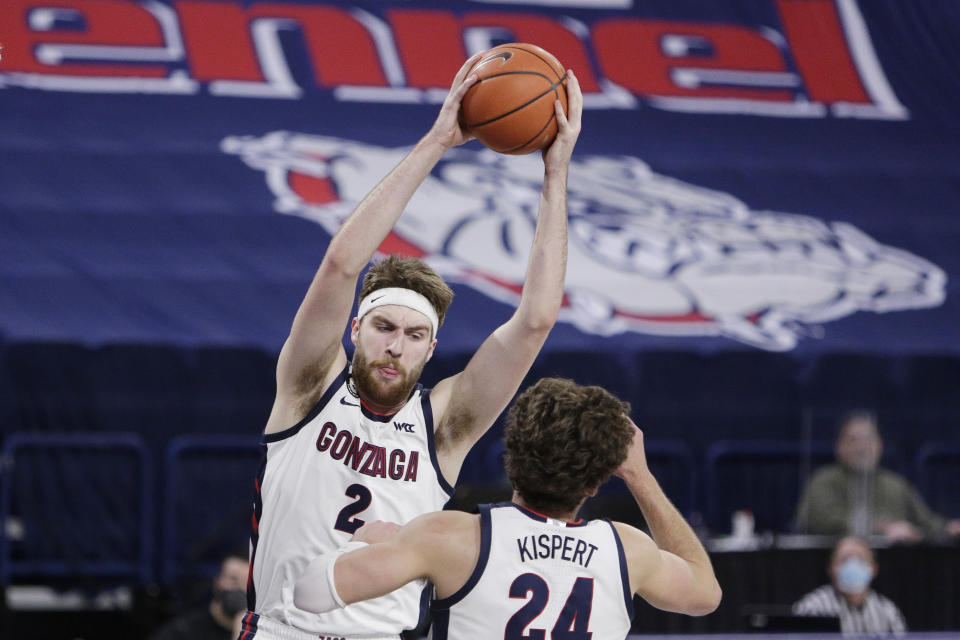 Gonzaga forward Drew Timme (2) grabs a rebound in front of forward Corey Kispert (24) during the first half of an NCAA college basketball game against Santa Clara in Spokane, Wash., Thursday, Feb. 25, 2021. (AP Photo/Young Kwak)