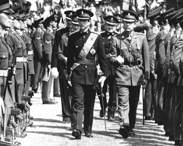 <p>UPI/Bettmann Archive/Getty Images</p> Prince Charles in uniform as the Colonel in Chief of the newly formed Royal Regiment of Wales at a vesting ceremony at Cardiff Castle in June 1969.