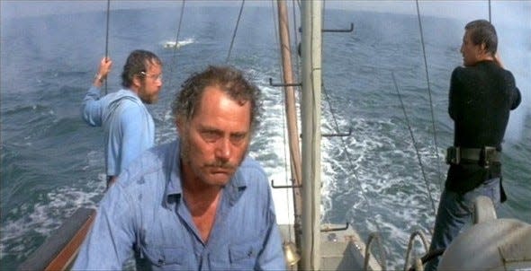 Robert Shaw (Quint), Richard Dreyfuss (Matt Hooper) and Roy Scheider (Police Chief Martin Brody) hunt a great white shark terrorizing the coastal community of Amity (Martha’s Vineyard) in the iconic Steven Spielberg shark thriller “Jaws.” Based on Peter Benchley’s 1974 novel of the same name, the 1975 film was one of the first summer blockbusters.