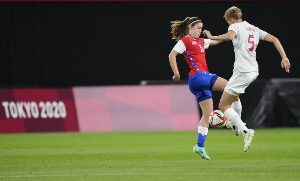 Canada's Quinn, right, and Chile's Rosario Balmaceda, left, battle for the ball during a women's soccer match at the 2020 Summer Olympics, Saturday, July 24, 2021, in Sapporo, Japan. (AP Photo/Silvia Izquierdo)