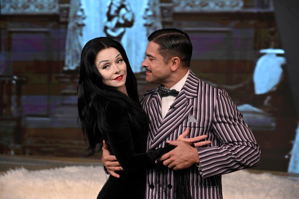 Married couple Kelly Ripa and Mark Consuelos embody the "mysterious and spooky" Morticia and Gomez Addams on "Live" on Oct. 23, 2019.