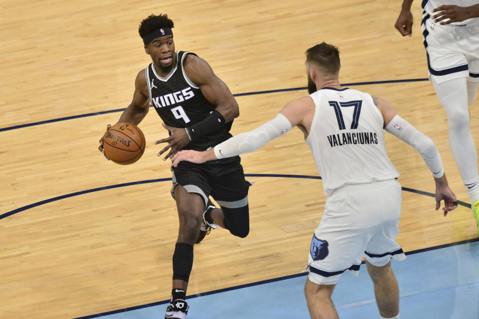 Sacramento Kings guard Terence Davis (9) drives against Memphis Grizzlies center Jonas Valanciunas (17) in the second half of an NBA basketball game Thursday, May 13, 2021, in Memphis, Tenn. (AP Photo/Brandon Dill)