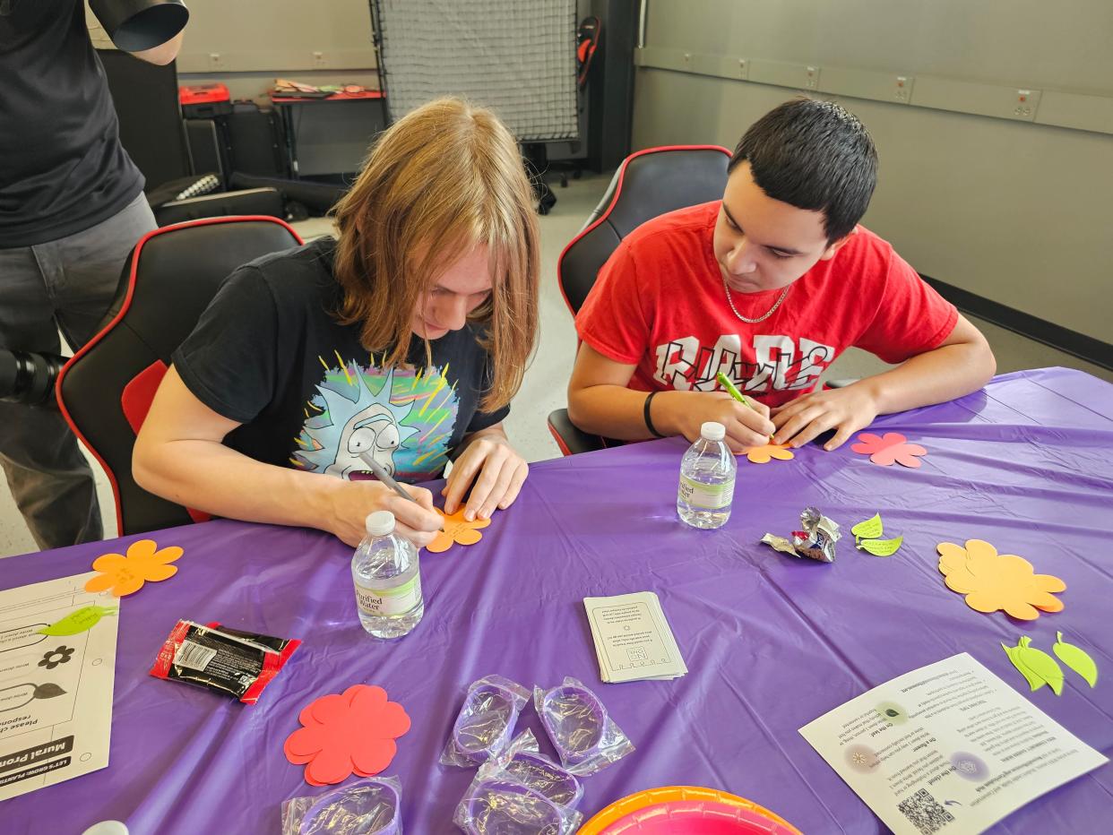 Zander Johnson, left, and Edgar Quintero, eighth graders at Crenshaw Middle School, work on creating pieces for a mural during the No One Eats Alone program. The program aims to break social isolation.