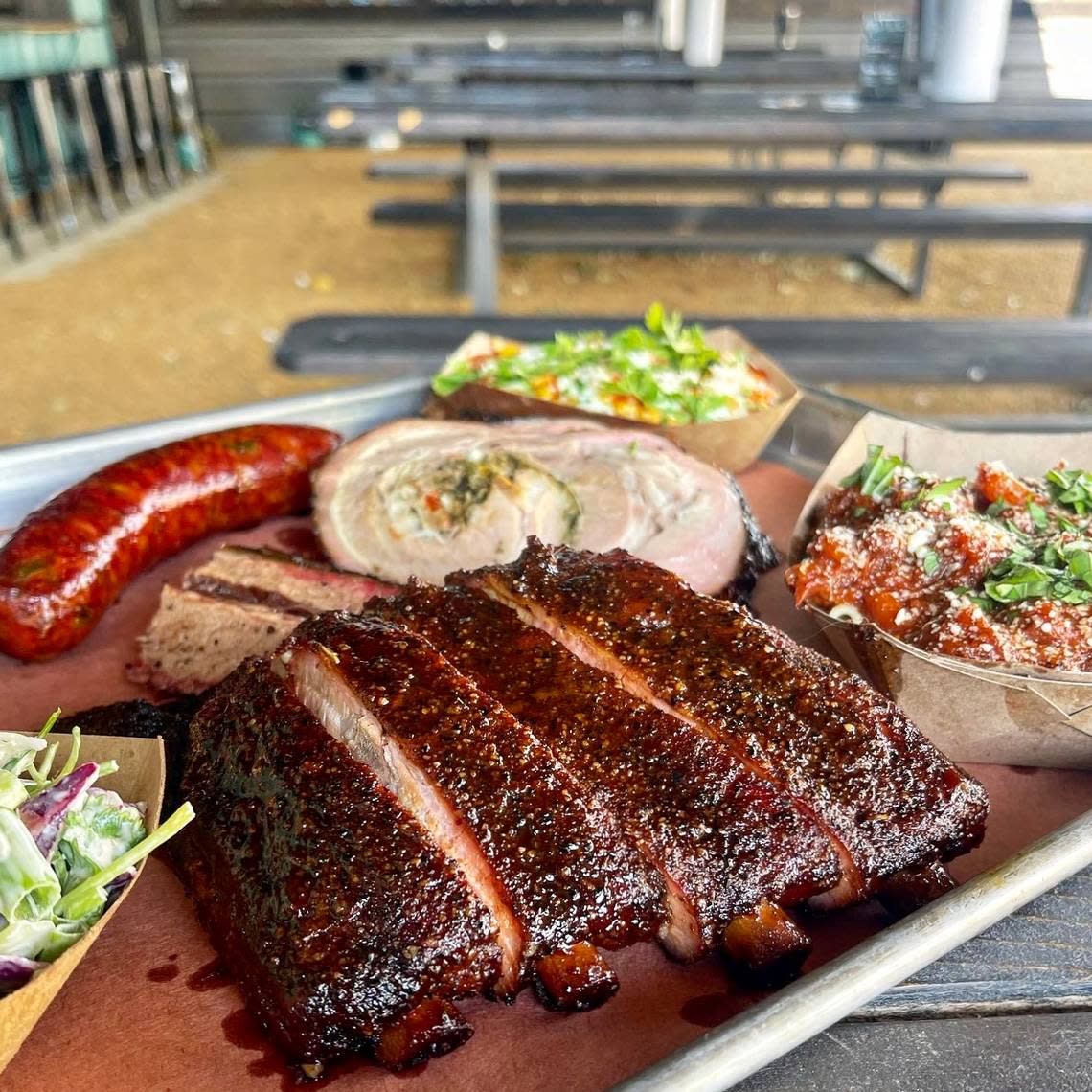 Ribs, stuffed pork belly,. sausage and sides at Brix Barbecue in Fort Worth. Handout photo
