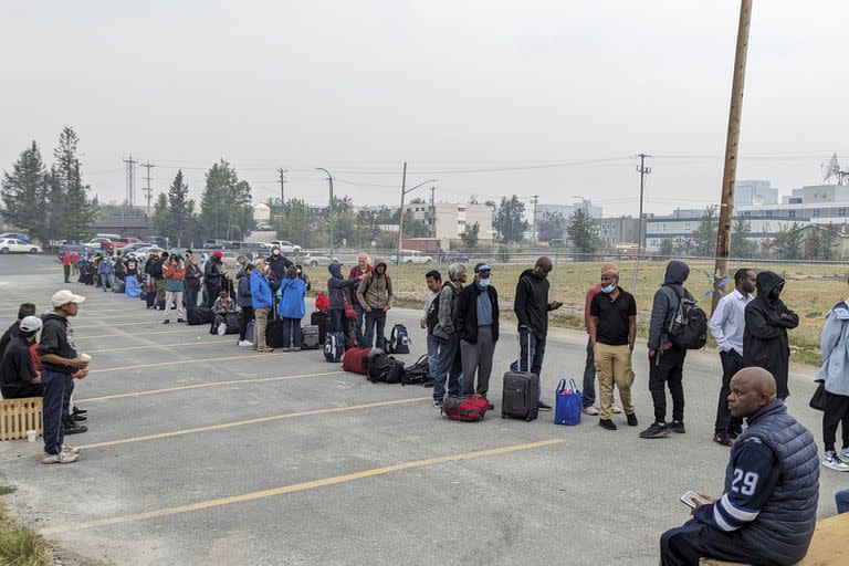 Personas sin vehículos hacen fila para registrarse para un vuelo a Calgary, Alberta en Yellowknife el jueves 17 de agosto de 2023