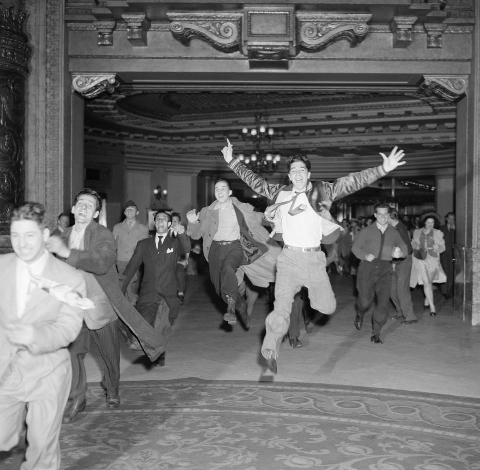 People run to a New York City box office to buy tickets to see musician Tommy Dorsey in 1943.