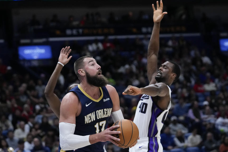 New Orleans Pelicans center Jonas Valanciunas (17) goes to the basket against Sacramento Kings forward Harrison Barnes (40) in the first half of an NBA basketball game in New Orleans, Wednesday, Nov. 22, 2023. (AP Photo/Gerald Herbert)