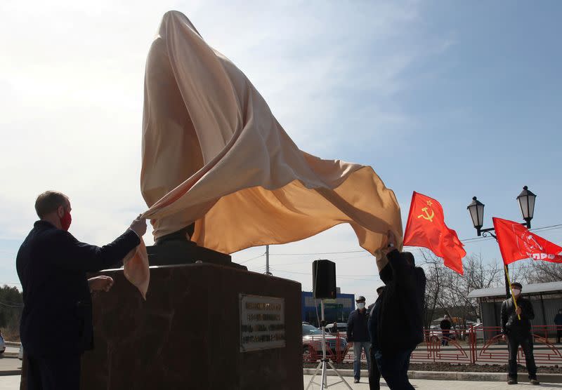 Members and supporters of the Russian Communist Party unveil a monument to Soviet state founder Vladimir Lenin in Sayansk