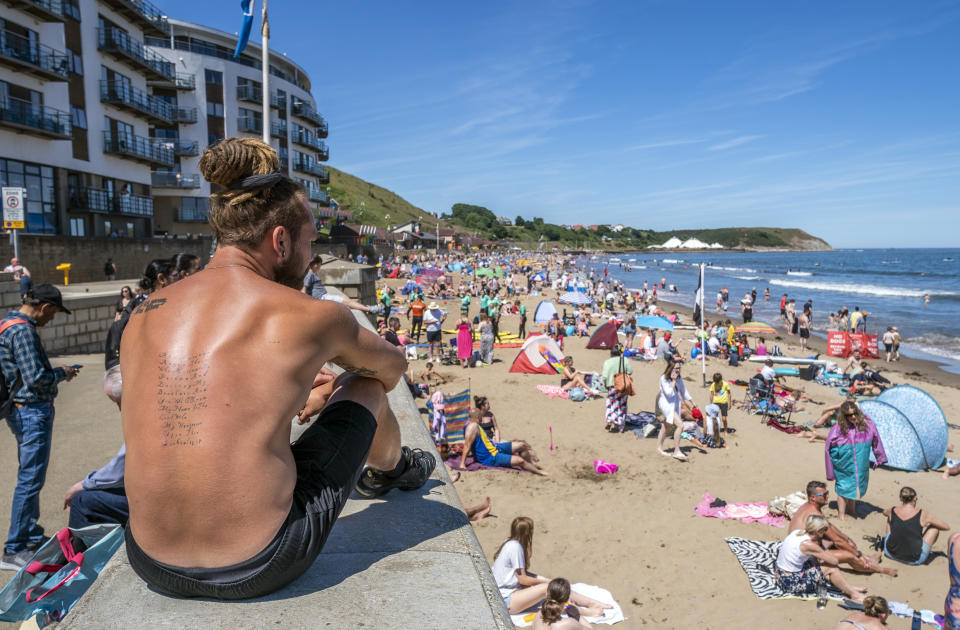 People enjoying the warm weather on Scarborough beach, North Yorkshire. Picture date: Sunday July 10, 2022.