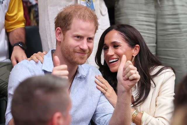 <p>Chris Jackson/Getty Images</p> Prince Harry and Meghan Markle attend the sitting volleyball match between Poland and Germany as fans sing "Happy Birthday" to him