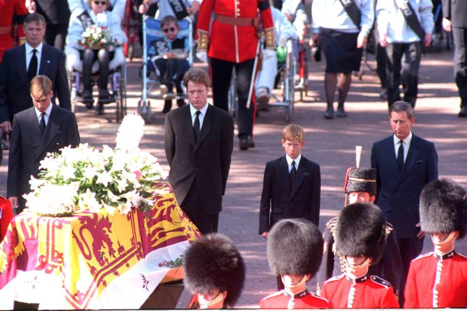 The young princes stand behind their mother's coffin at the funeral at Westminster Abbey (Adam Butler/PA)