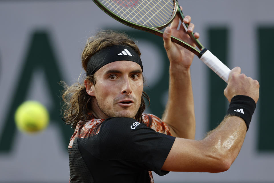 Greece's Stefanos Tsitsipas plays a shot against Argentina's Diego Schwartzman during their third round match of the French Open tennis tournament at the Roland Garros stadium in Paris, Friday, June 2, 2023. (AP Photo/Jean-Francois Badias)