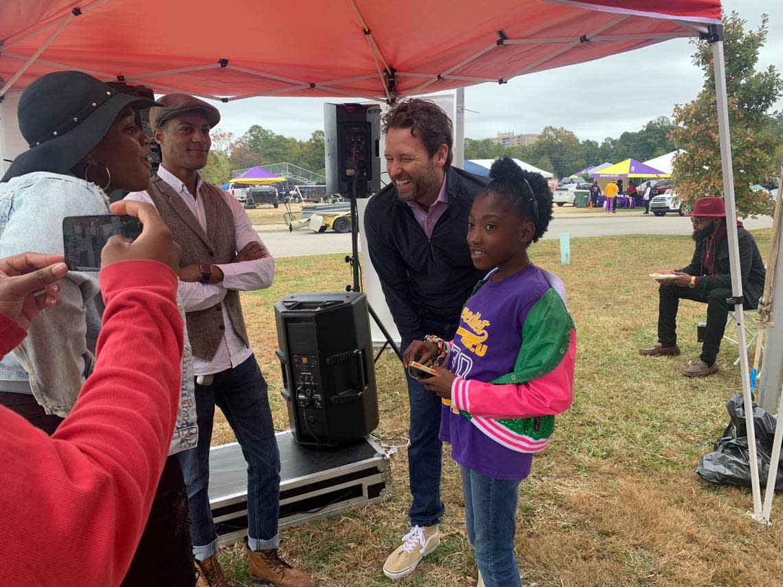 Democratic nominee for South Carolina Governor Joe Cunningham takes a photo with Londyn Springs, 9, of Columbia, outside of Charles W. Johnson Stadium Saturday, Oct. 29, 2022 before Benedict College’s homecoming football game.