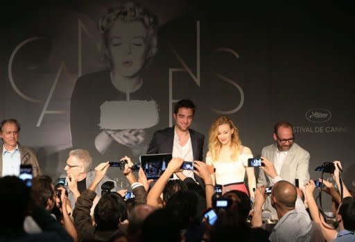 British actor Robert Pattinson (C) with Canadian actress Sarah Gadon (2R) and US actor Paul Giamatti (R) at the press conference of "Cosmopolis" presented in competition at the 65th Cannes film festival in Cannes on May 25. Money, sex and stretch limos abound in David Cronenberg film