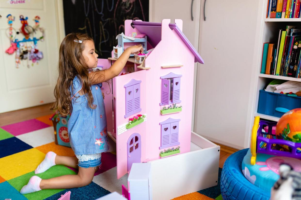 Do dollhouses possess the potential to inspire young girls to design and build? <a href="https://www.gettyimages.com/detail/photo/curious-playful-girl-arranging-her-doll-house-while-royalty-free-image/1267317545?phrase=girl+dollhouse+purple&adppopup=true" rel="nofollow noopener" target="_blank" data-ylk="slk:Kosamtu via Getty Images;elm:context_link;itc:0;sec:content-canvas" class="link ">Kosamtu via Getty Images</a>