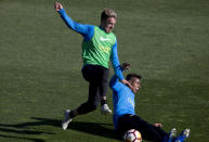 Boca Junior's Julio Buffarini, left and Sebastian Villa challenge for the ball during a training session in Madrid, Spain, Thursday, Dec. 6, 2018. The Copa Libertadores Final will be played on Dec. 9 in Spain at Real Madrid's stadium for security reasons after River Plate fans attacked the Boca Junior team bus heading into the Buenos Aires stadium for the meeting of Argentina's fiercest soccer rivals last Saturday. (AP Photo/Paul White)