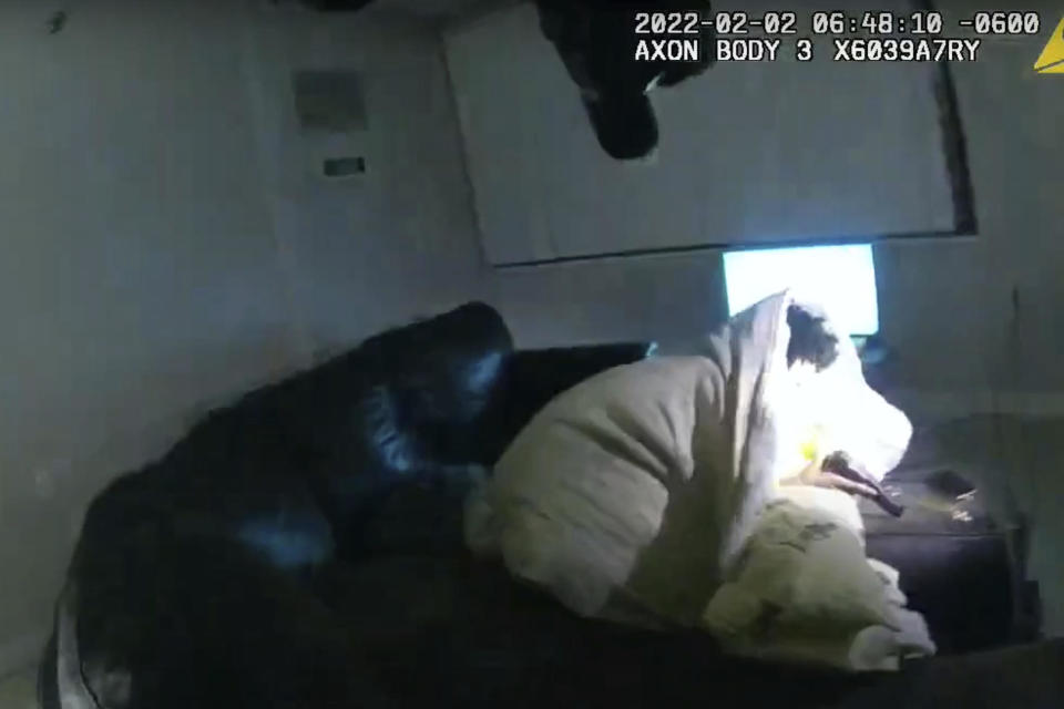 In this image taken from Minneapolis Police Department body camera video and released by the city of Minneapolis, 22-year-old Amir Locke wrapped in a blanket on a couch holding a gun moments before he was fatally shot by Minneapolis police as they were executing a search warrant in a homicide investigation on Wednesday, Feb. 2, 2022, in Minneapolis.  / Credit: Minneapolis Police Department via AP