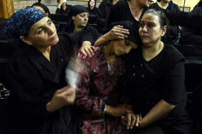 Relatives of killed Coptic Christians grieve during a funeral at Abu Garnous Cathedral in the north Minya town of Maghagha, on May 26, 2017