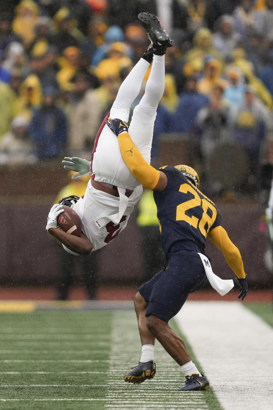 Indiana wide receiver Omar Cooper Jr. (3) is tackled by Michigan defensive back Quinten Johnson (28) in the second half of an NCAA college football game in Ann Arbor, Mich., Saturday, Oct. 14, 2023. (AP Photo/Paul Sancya)