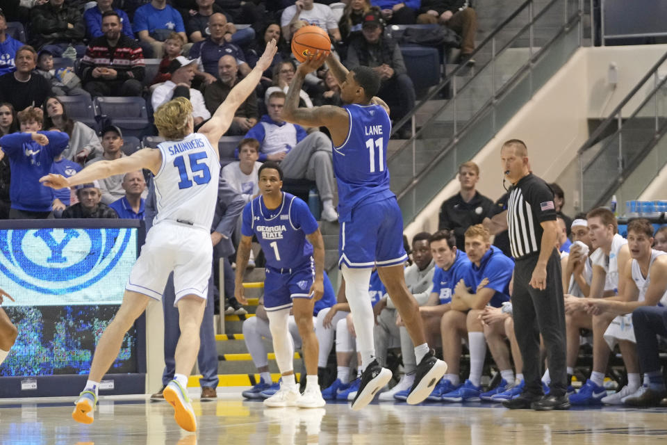 Georgia State guard Toneari Lane (11) shoots as BYU guard Richie Saunders (15) defends during the first half of an NCAA college basketball game Saturday, Dec. 16, 2023, in Provo, Utah. (AP Photo/Rick Bowmer)