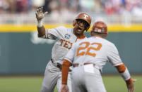 Texas' Cam Williams, left, celebrates with head coach David Pierce while rounding the bases after hitting a two-run home run in the second inning against Mississippi State during a baseball game in the College World Series Saturday, June 26, 2021, at TD Ameritrade Park in Omaha, Neb. (AP Photo/Rebecca S. Gratz)