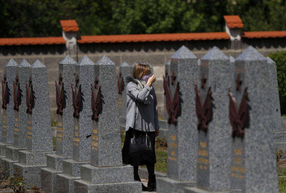 In this photo taken on Wednesday, May 6, 2020, a woman walks by the Soviet World War II memorial in Prague, Czech Republic. Relations between the Czech Republic and Russia have taken a turn for the worse in a series of disputes over the interpretation of historical events. Three Prague politicians whose recent actions upset Russia have been placed under police protection amid a media report that Russian intelligence services have been plotting to poison them with the deadly toxin ricin. Russia has opened a criminal investigation into Prague's removal of a war memorial to a World War II hero, among other actions that have tested diplomatic ties. (AP Photo/Petr David Josek)