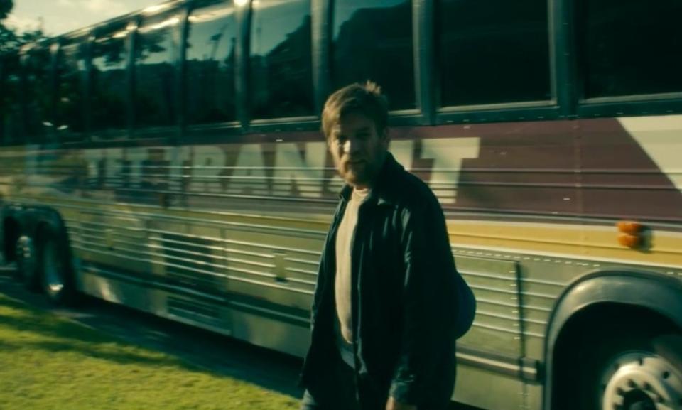 Dan walking in front of a Tet Transit bus in "Doctor Sleep"