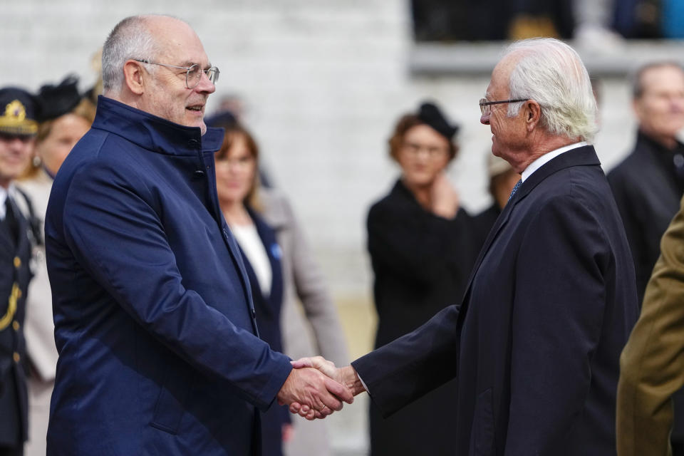 Sweden's King Carl XVI Gustaf, right, and Estonian President Alar Karis shake hands during an official welcoming ceremony at Vabaduse (Freedom) square in Tallinn, Estonia, Tuesday, May 2, 2023. (AP Photo/Pavel Golovkin)