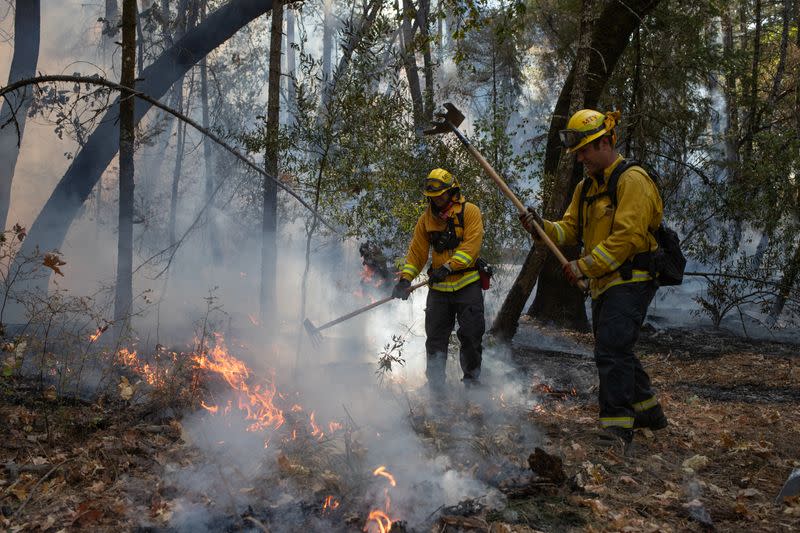 Fireman create fire line after firing operation near Glass Fire in Calistoga, California
